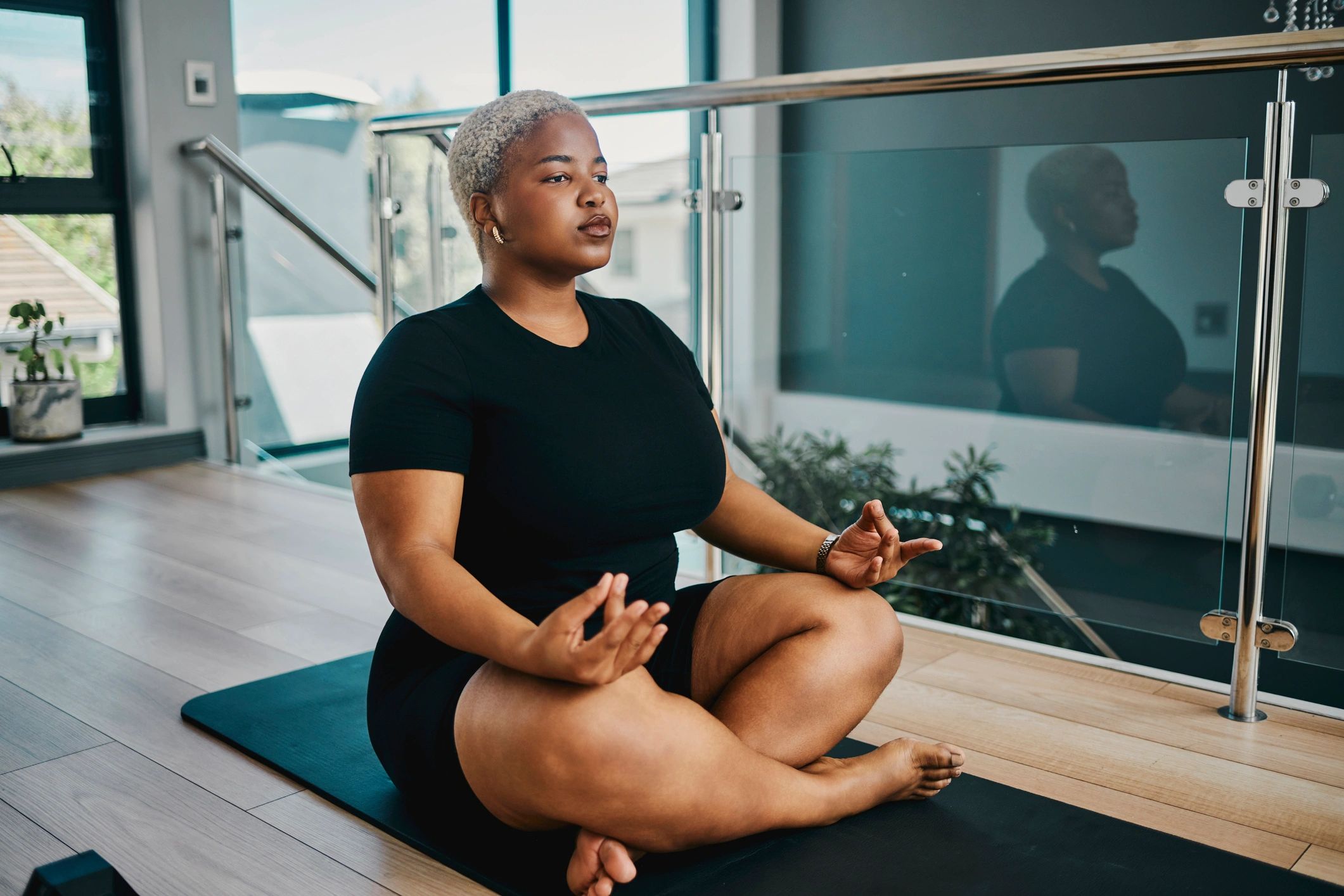 Woman meditating calmly indoors